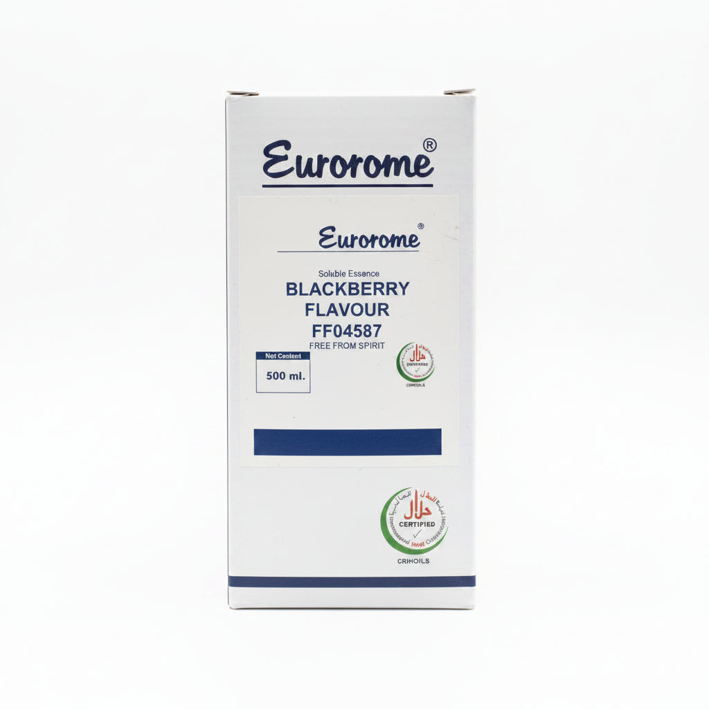 A hand holding a box of Eurorome Blackberry Flavour soluble essence, showing the front label and product details, with other boxes and containers visible in the background.