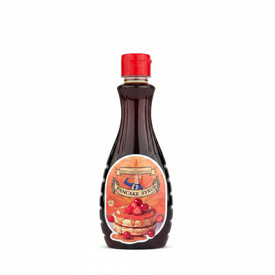 Bottle of pancake syrup with a red cap on a gray background
