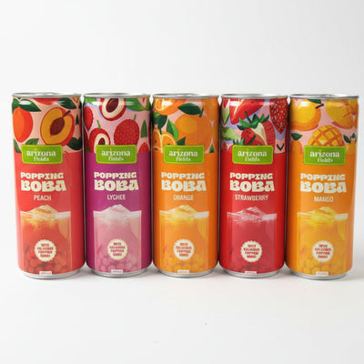 Five cans of Arizona Popping Boba drinks on a surface with a blurred background.