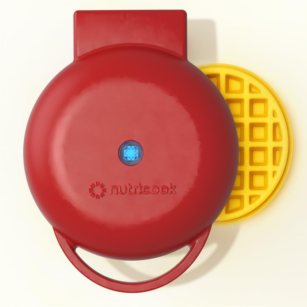Red waffle maker with a yellow waffle on a white background