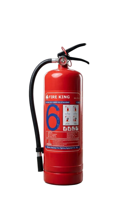 A red Fire King portable fire extinguisher with a black hose and handle, standing upright on a gray studio floor with softbox lights visible in the background.