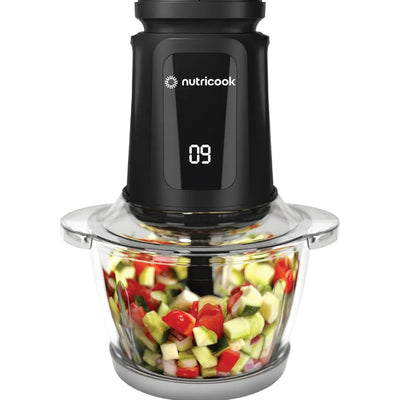 Nutricook blender with chopped vegetables inside on a white background