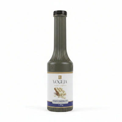 Bottle of Voglia white chocolate syrup on a table with a blurred background
