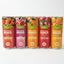Five cans of Arizona Popping Boba drinks on a surface with a blurred background.