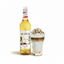A bottle of Le Froid de Monin French Vanilla syrup stands next to a layered latte topped with whipped cream and chocolate shavings on a white background.