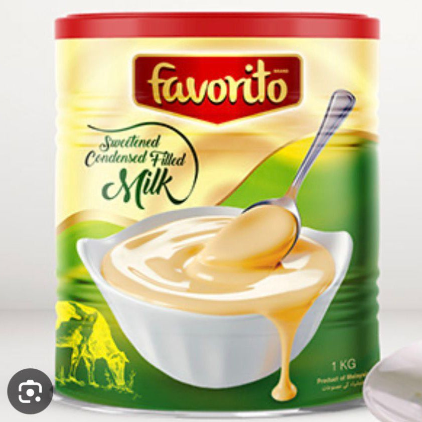 Can of Favorito sweetened condensed milk with a spoonful of milk on a white background
