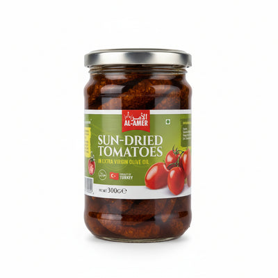 Jar of sun-dried tomatoes with Al-Amer brand label held by a hand.