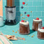Magic Bullet blender with dessert cups on a blue tiled background