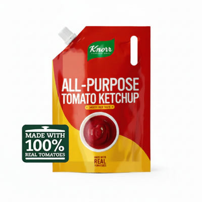 Knorr All-Purpose Tomato Ketchup pouch in red and yellow packaging with a white spout, shown on a white background with a green 'Made with 100% Real Tomatoes' badge.