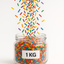 rainbow sprinkles falling into a jar container. 1 KG written on label 